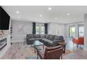 Comfortable living room with a gray sofa, fireplace, recessed lights, and stylish decor at 120 Vanira Se Ave, Atlanta, GA 30315