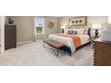 Cozy bedroom with neutral walls, carpet floors, decorative accents, and a well-lit atmosphere at 1208 Arnhem Dr, Hampton, GA 30228