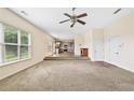 Spacious living room with open view of kitchen, featuring large windows for natural light at 1212 Ashton Park Dr, Lawrenceville, GA 30045