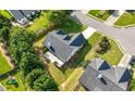 Aerial view of a suburban home with a spacious backyard, patio, and well-kept landscaping at 3313 Harmon Ridge Ct, Buford, GA 30519