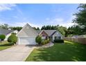Charming single-story home with a well-manicured lawn and attached two-car garage at 3313 Harmon Ridge Ct, Buford, GA 30519