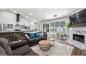Open concept living room and kitchen with stainless steel appliances and a cozy fireplace at 3313 Harmon Ridge Ct, Buford, GA 30519