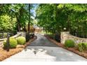Long private driveway with stone gate posts leads to this beautiful home at 390 Hembree Rd, Roswell, GA 30075