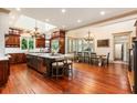 Spacious kitchen with dark wood cabinets, large island, and stainless steel appliances at 390 Hembree Rd, Roswell, GA 30075