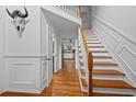 Bright foyer with hardwood floors, a staircase, and decorative trim at 125 Winter Valley Ct, Fayetteville, GA 30215