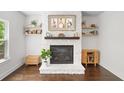 Cozy living room with a stone fireplace and floating shelves at 178 Crestbrook Way, Dallas, GA 30157