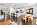 Open-concept living space featuring hardwood floors, island, and dining area at 178 Crestbrook Way, Dallas, GA 30157