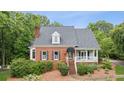Beautiful home with brick facade, black shutters, and a welcoming front porch at 2610 Ginger Dr, Buford, GA 30519