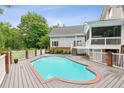 Outdoor pool surrounded by a wooden deck, white railings, and manicured backyard at 2610 Ginger Dr, Buford, GA 30519