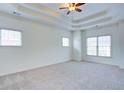 Bright bedroom with tray ceilings, ceiling fan, carpeted floors and large windows at 5004 Duxford Se Dr, Smyrna, GA 30082