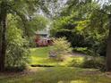 Two-story home with a red deck surrounded by lush greenery and a well-maintained lawn at 998 Northrope Ne Dr, Atlanta, GA 30324