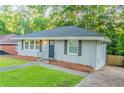 Charming single-story home with a well-maintained lawn and a dark-colored front door at 1760 Spring Ave, Atlanta, GA 30344