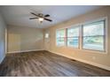 Inviting living room with wood-look floors, ceiling fan, and natural light from large windows at 1760 Spring Ave, Atlanta, GA 30344