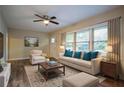 Bright living room with wood floors, a ceiling fan, and a comfortable seating arrangement with backyard view at 1760 Spring Ave, Atlanta, GA 30344