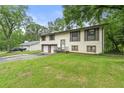 Traditional split-level home with a front lawn and two-car garage at 2501 Northbrook Rd, Snellville, GA 30039