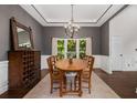 Traditional dining room with rustic wood table, chandelier, and ample natural light at 1143 Brookhaven North Cir, Brookhaven, GA 30319