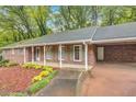The front of this brick home features a covered porch, carport and well-maintained landscaping at 333 Lynne Cir, Alpharetta, GA 30009