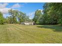 Spacious property featuring a well-maintained lawn, mature trees, and a charming single-story home at 1554 Owens Store Road Rd, Canton, GA 30115