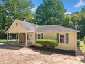 Inviting single-story home with covered porch and well-maintained front yard landscaping at 1554 Owens Store Road Rd, Canton, GA 30115