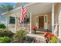 Inviting front porch with American flag and cozy seating at 2145 Kensington Sw Ct, Marietta, GA 30064