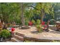 Stone patio with fire pit, seating, and landscaped surroundings at 2145 Kensington Sw Ct, Marietta, GA 30064