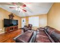 Comfortable living room showcasing hardwood floors, a TV, and leather seating arrangement at 295 Pinehurst Dr, Stockbridge, GA 30281
