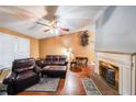 Cozy living room featuring hardwood floors, fireplace, and comfortable leather seating at 295 Pinehurst Dr, Stockbridge, GA 30281