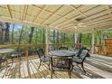 Spacious covered deck featuring outdoor seating, perfect for enjoying nature and outdoor relaxation at 3115 Chimney Cove Ln, Cumming, GA 30041