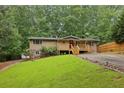Charming home with a blend of stone and siding, a well-maintained lawn, and a inviting front porch at 3115 Chimney Cove Ln, Cumming, GA 30041