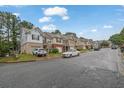 Street view of townhomes showcasing the neighborhood's well-maintained exteriors and community feel at 4055 Hill Station Ct, Sugar Hill, GA 30518