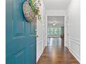 Bright foyer with hardwood floors and white trim, leading to a sunlit living area at 6360 Waveland Dr, Cumming, GA 30040