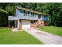 Two-story home with brick and siding, featuring an attached garage and a covered porch at 10 Canyon Cove Cv, Ellenwood, GA 30294