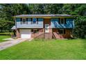 Exterior elevation of two-story home with brick and siding, and well-maintained lawn at 10 Canyon Cove Cv, Ellenwood, GA 30294