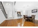 Open dining room featuring hardwood floors, modern lighting, and a view of the breakfast bar at 3280 Stillhouse Se Ln # 410, Atlanta, GA 30339
