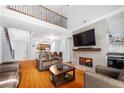 Bright living room with hardwood floors, fireplace, and an open view of the kitchen area at 3280 Stillhouse Se Ln # 410, Atlanta, GA 30339