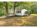 Lovely two-story home showcasing a clean white exterior, contrasting black accents, and a beautifully landscaped front yard at 4510 Virginia Nw Ave, Kennesaw, GA 30144