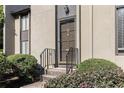 Close-up of a front entrance with well-maintained landscaping and a welcoming exterior light fixture at 26 Ivy Ne Pkwy, Atlanta, GA 30342