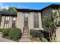 Two-story home with neutral-toned siding, complemented by manicured shrubs and trees and a warm and inviting entrance at 26 Ivy Ne Pkwy, Atlanta, GA 30342
