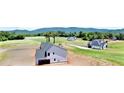 Expansive aerial view showcases the home's location amidst a lush, green landscape at 301 Eminence Peak, Rydal, GA 30171
