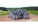 A gorgeous exterior view highlights the stone accents and covered porch of this stately home at 301 Eminence Peak, Rydal, GA 30171