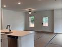 Open-concept living area with ample natural light and a view into the kitchen at 3230 Cyrus Creek Dr, Kennesaw, GA 30152