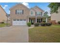 Charming two-story brick home with a well-maintained lawn and attached two car garage at 4945 Racquet Ct, Duluth, GA 30096
