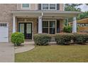 Inviting front porch with white columns and manicured shrubbery creating a welcoming entrance at 4945 Racquet Ct, Duluth, GA 30096