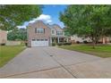 Charming two-story brick home with a well-maintained lawn and attached two car garage at 4945 Racquet Ct, Duluth, GA 30096