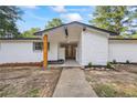 A front exterior featuring a white painted brick facade, and a newly landscaped front yard at 1377 Hill Sw Dr, Conyers, GA 30094