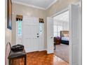 Inviting foyer featuring hardwood floors, a stylish bench, and a view into a bedroom at 1574 Glenfield Dr, Lawrenceville, GA 30043