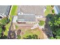 Aerial view of backyard featuring patio area, hardscape path, and mature trees at 445 Sweet Ivy Ln, Lawrenceville, GA 30043