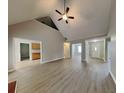Bright living room features vaulted ceiling, modern ceiling fan, and updated floors at 115 Hugh Dr, Covington, GA 30016