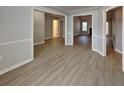 Open living space with light grey walls, white trim, and new floors at 115 Hugh Dr, Covington, GA 30016