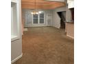 Spacious living room featuring plush carpeting, ample natural light, and neutral paint at 162 Ledgewood Mill Way, Lawrenceville, GA 30045